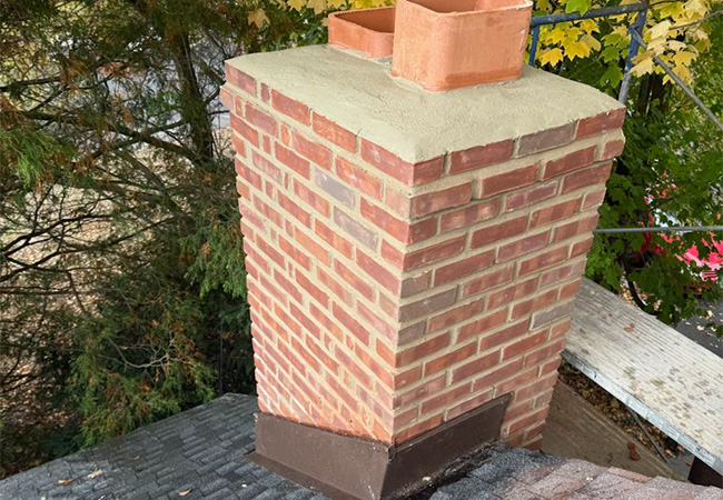 Chimney flashing and masonry repair on a residential roof in Bergen County