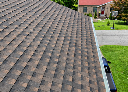 Residential asphalt shingle roof with repaired damaged and deteriorated shingles